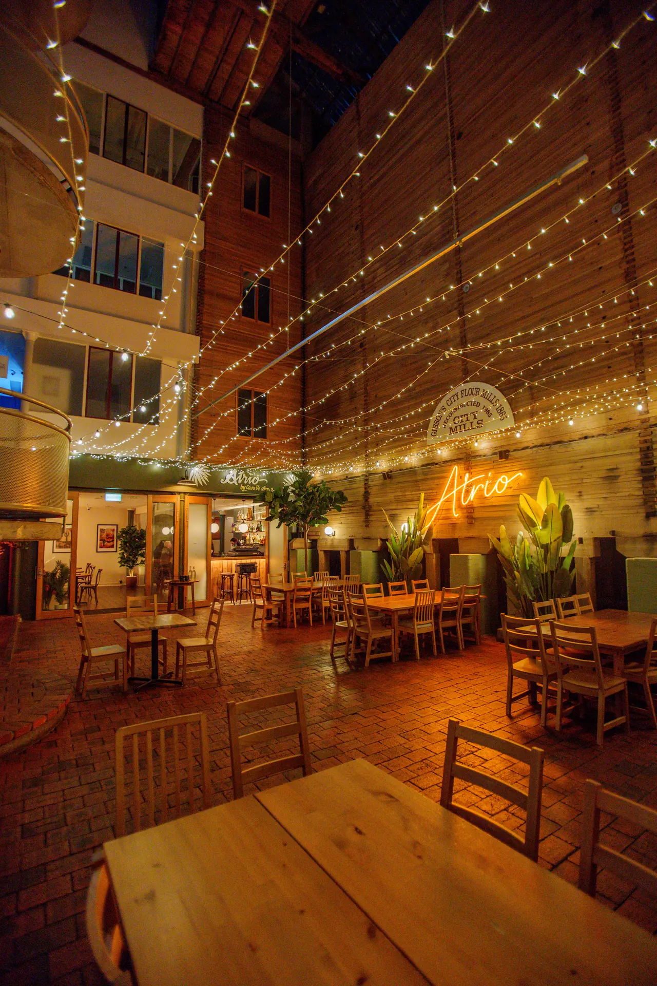 Atrio entrance and courtyard seating at night