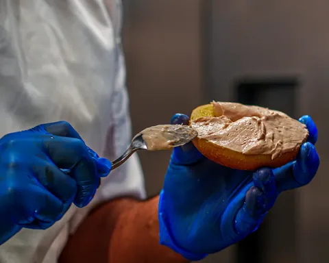 Cream cheese being spread on an Atrio bagel