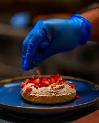 Fresh strawberry bagel being prepared