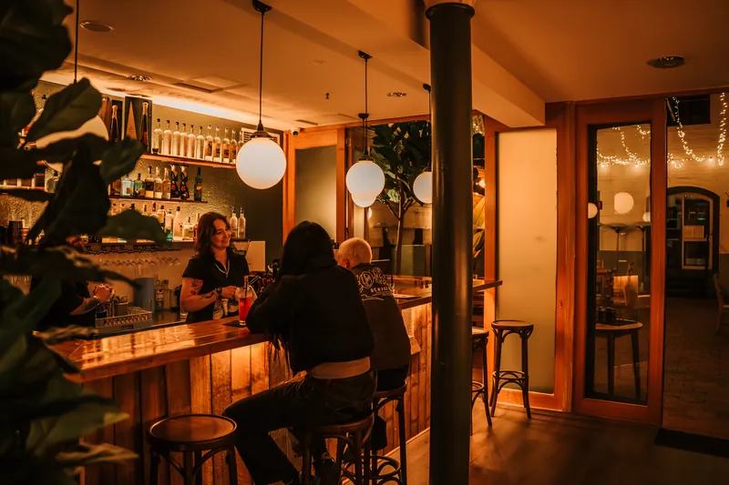 Guests and staff at the Atrio bar inside Gibsons Mill